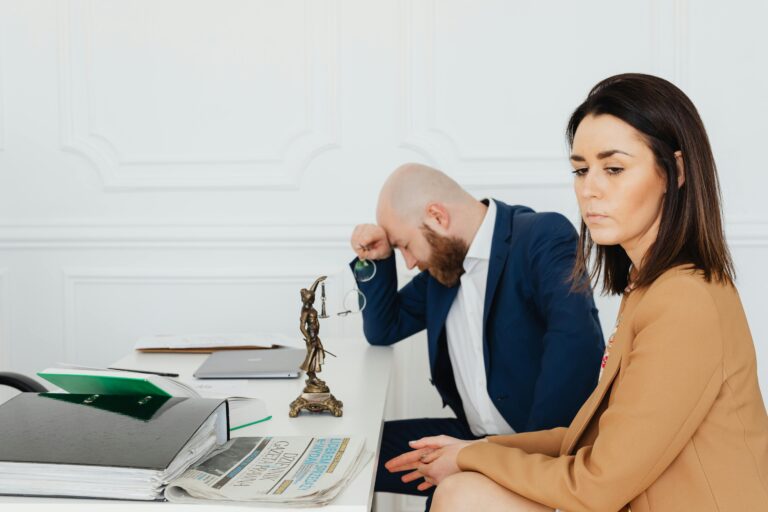 A couple consulting with their lawyer in an office setting, discussing divorce.